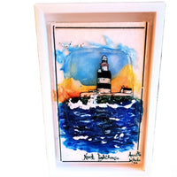 "Handcrafted fused glass art of Hook Lighthouse, showcasing vibrant ocean waves, a sunset sky, and intricate details in a custom wood frame."