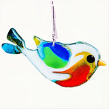 Beautiful fun fused glass suncatcher created by hand featuring crisp 
white body with red, orange, yellow breast.  Blue, green and yellow wing. 